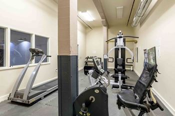A gym with treadmills, weights, and exercise machines.